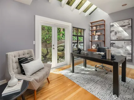 a living room with furniture a rug and a large window