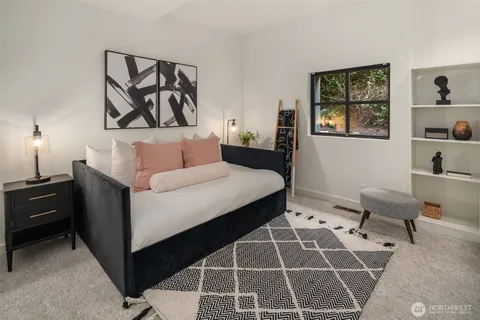 a living room with a couch and a potted plant