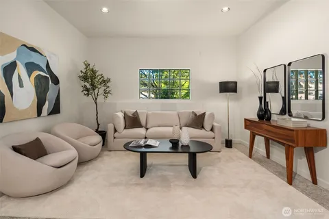 a living room with furniture and a potted plant