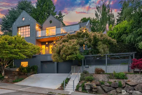 a front view of a house with plants