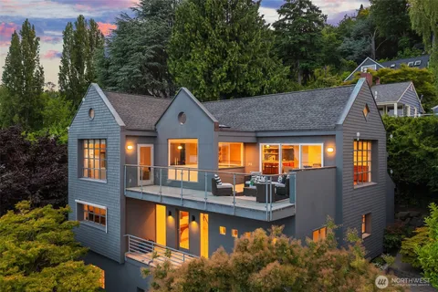 a view of a house with swimming pool next to a yard