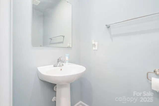 a bathroom with a sink a toilet and mirror