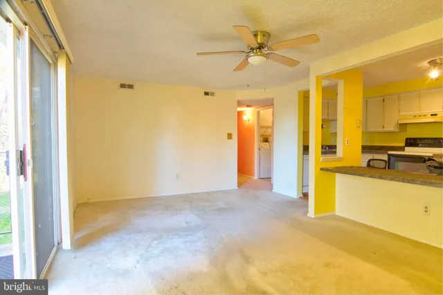 a view of a kitchen with a sink and a refrigerator