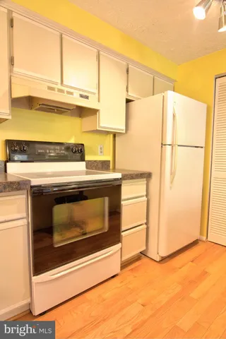 a kitchen with a stove and a refrigerator