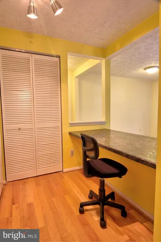a view of a room with furniture and wooden floor