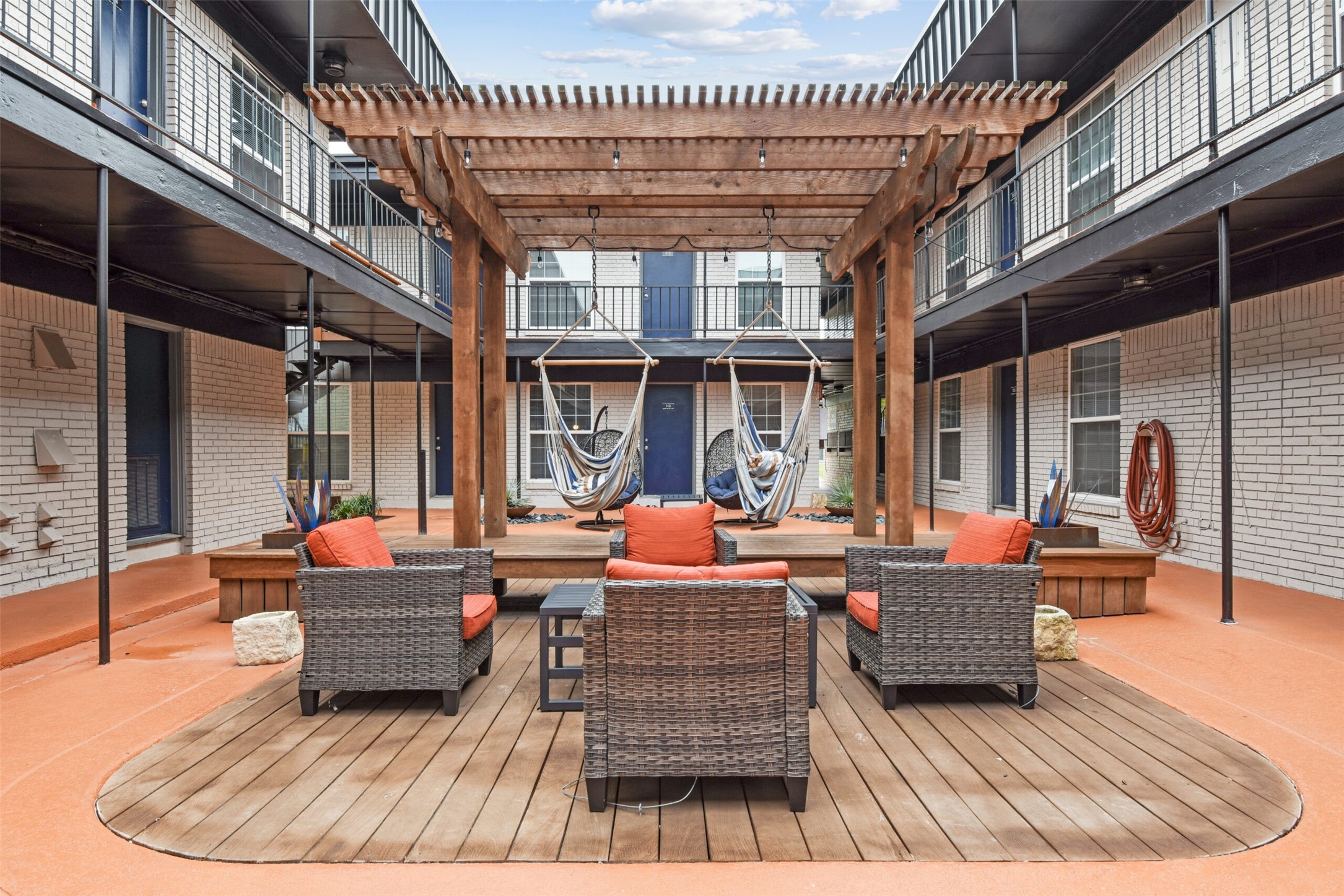 2410 Longview Street, Unit D204 Austin, TX 78705 - Photo 8 of 9 a outdoor space with patio the couches and a dining table and chairs with wooden floor