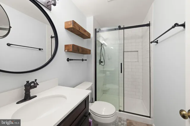 a bathroom with a sink toilet and shower