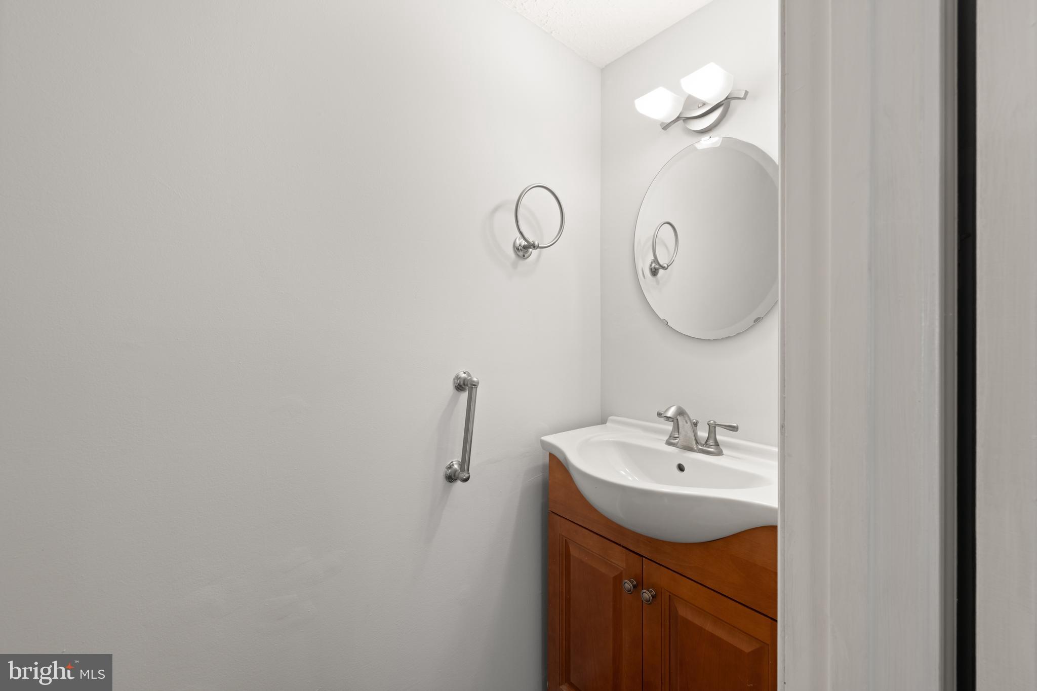 11321 Crescendo Place Silver Spring, MD 20901 - Photo 18 of 24 a bathroom with a sink and mirror