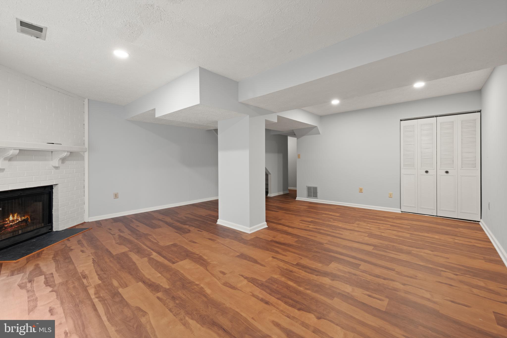 11321 Crescendo Place Silver Spring, MD 20901 - Photo 21 of 24 a view of empty room with wooden floor and fireplace