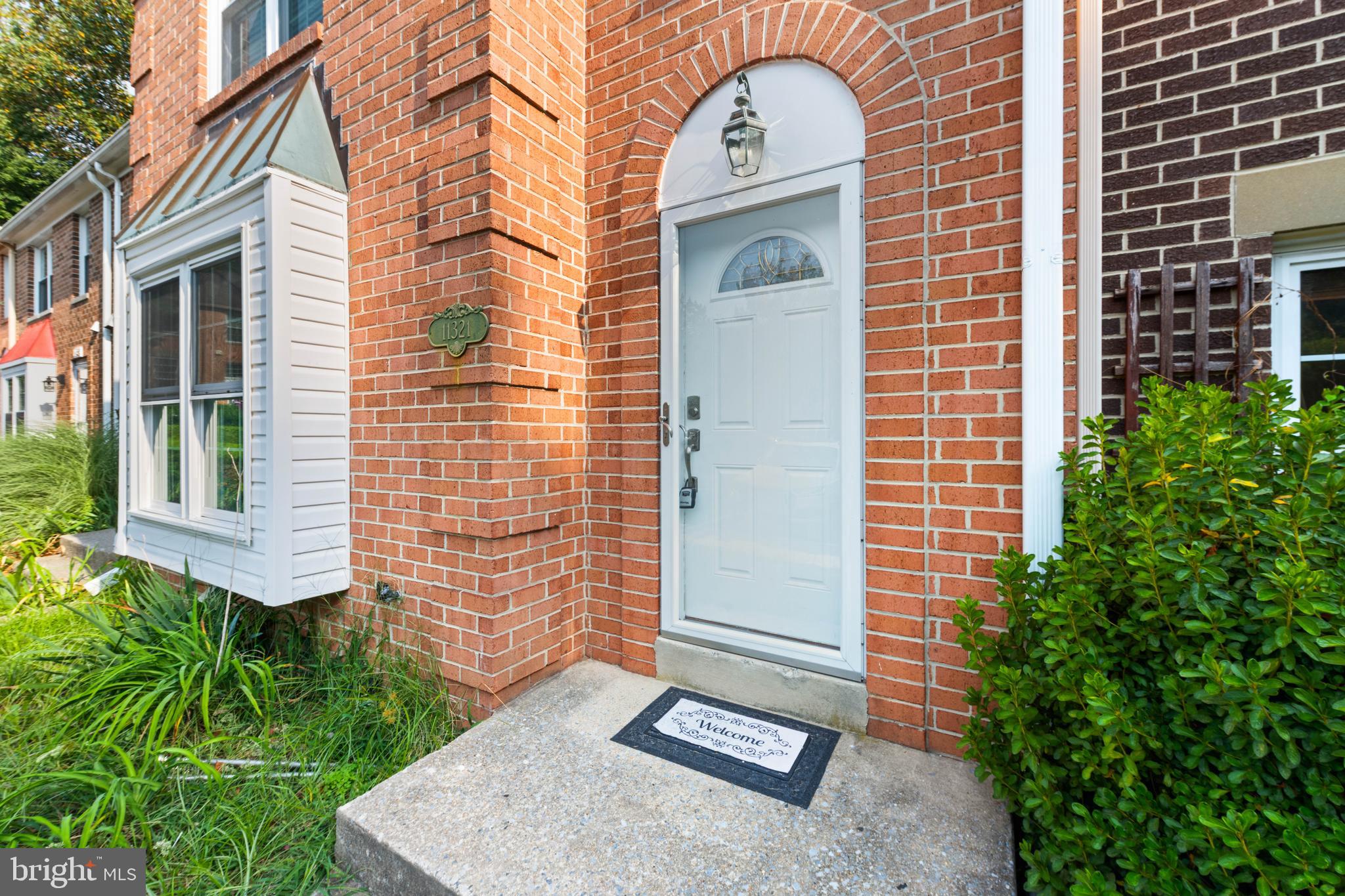 11321 Crescendo Place Silver Spring, MD 20901 - Photo 3 of 24 a front view of a house with a garden