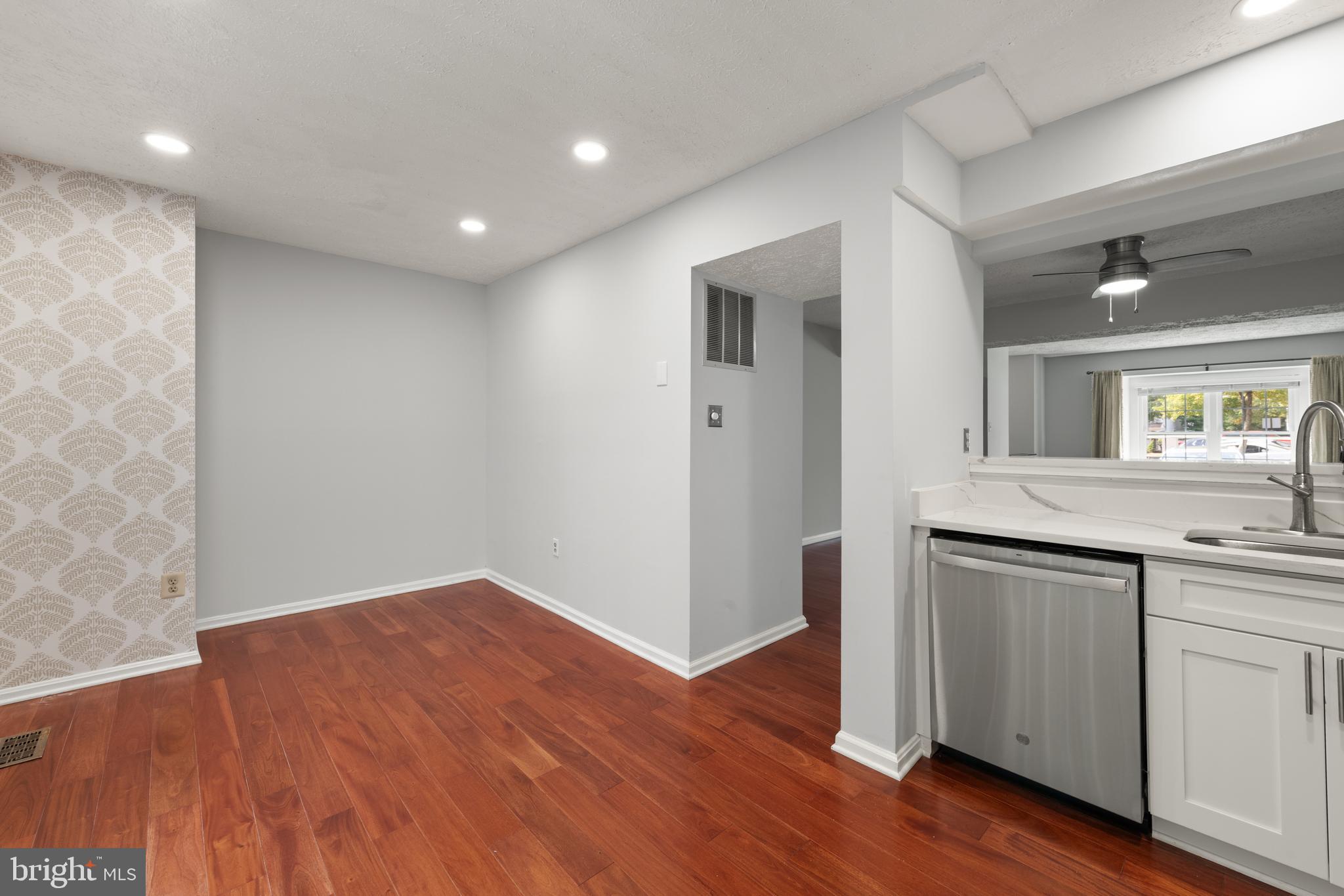 11321 Crescendo Place Silver Spring, MD 20901 - Photo 4 of 24 an empty room with wooden floor and mirror