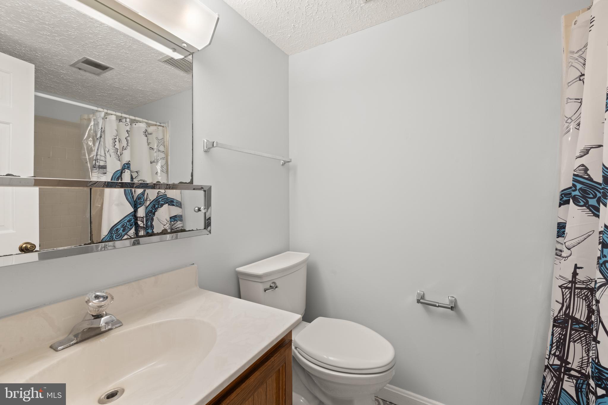 11321 Crescendo Place Silver Spring, MD 20901 - Photo 6 of 24 a bathroom with a sink mirror vanity and toilet