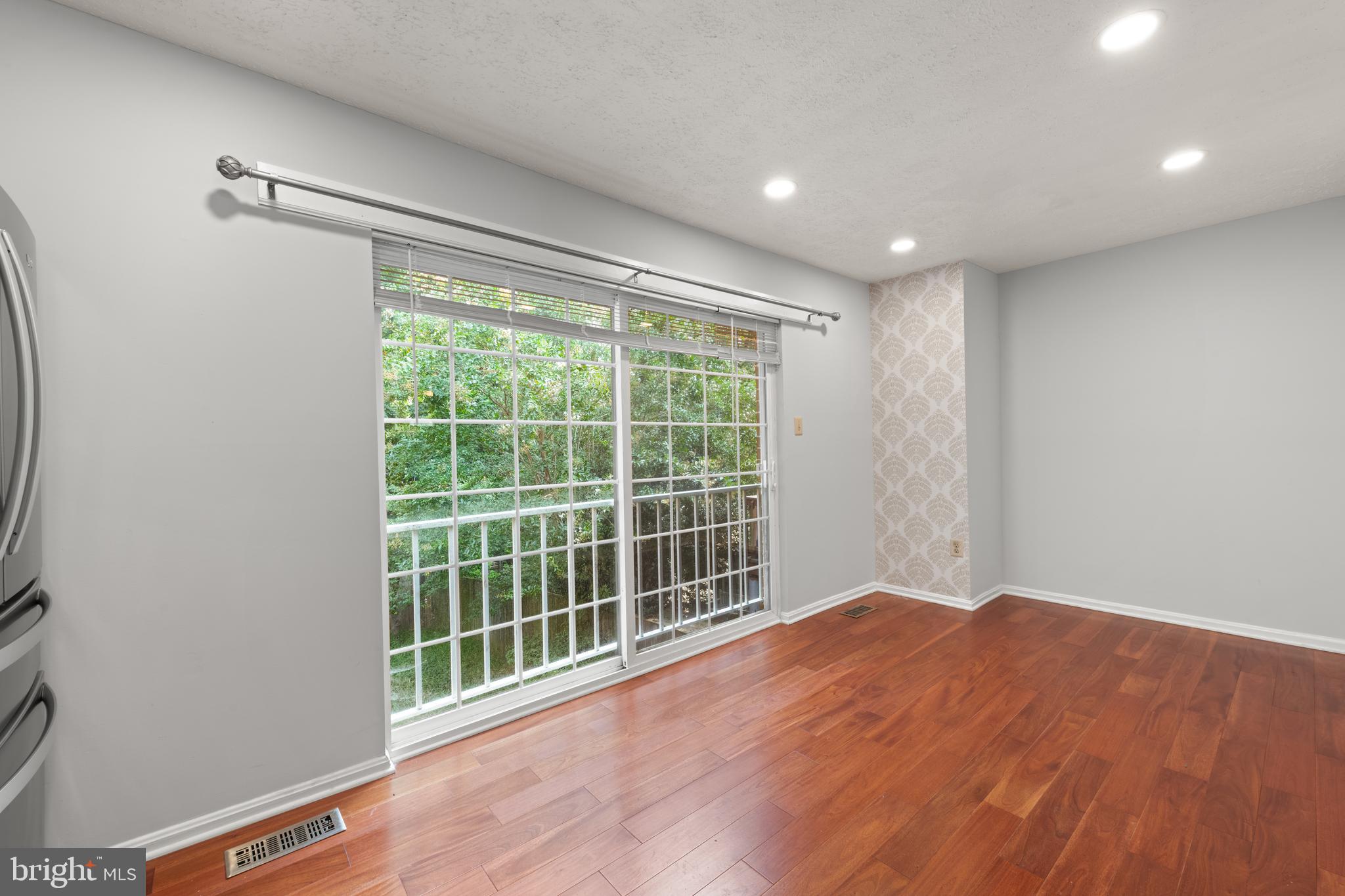 11321 Crescendo Place Silver Spring, MD 20901 - Photo 8 of 24 a view of an empty room with wooden floor and a window