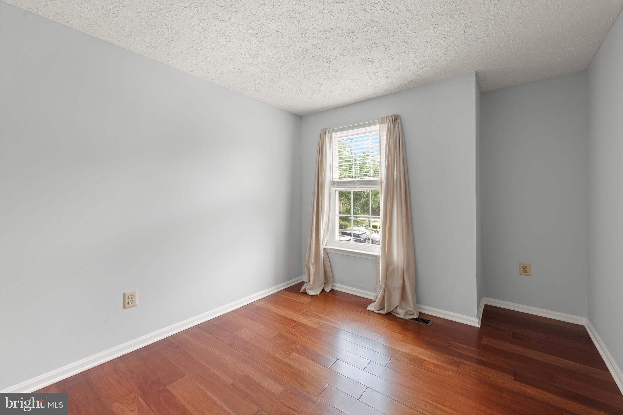 11321 Crescendo Place Silver Spring, MD 20901 - Photo 10 of 24 an empty room with wooden floor and windows