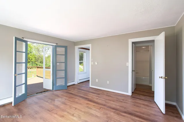 a living room with furniture a flat screen tv and a window