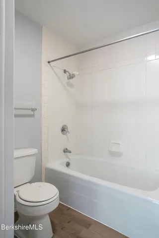 a bathroom with a sink a toilet and shower curtain