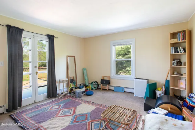 a view of a house with a big yard and large trees
