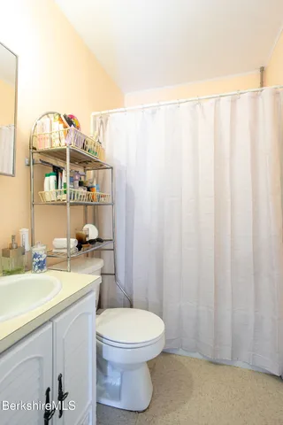 a living room with furniture and a mirror