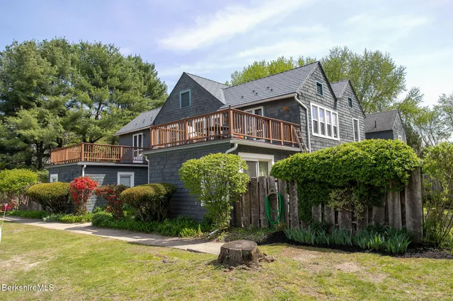 a front view of house with a garden