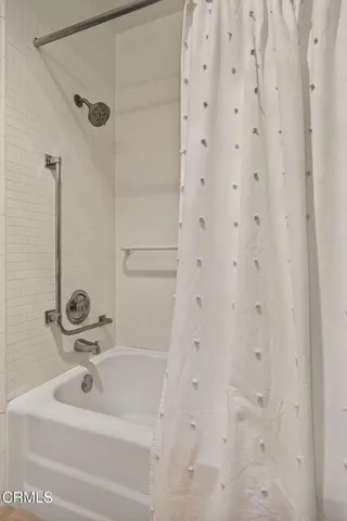 a bathroom with a glass shower door