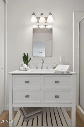 a living room with furniture floor to ceiling window and a flat screen tv