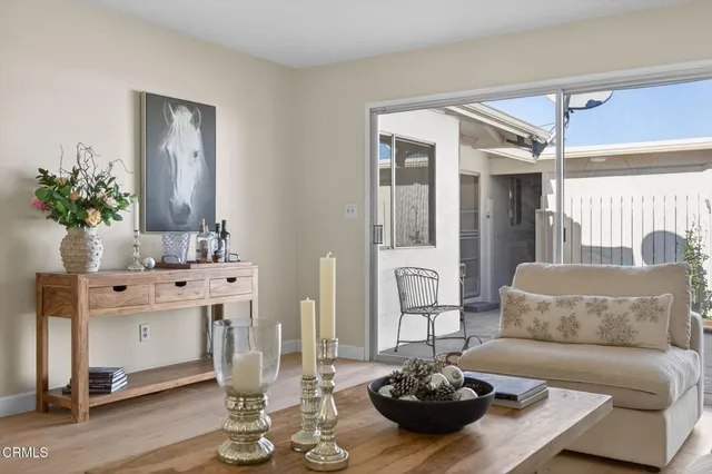 a view of a dining room with furniture and a potted plant