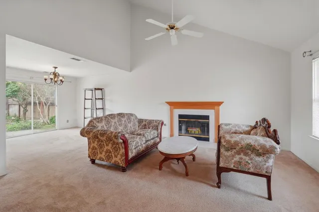 a living room with furniture a lamp and a fireplace