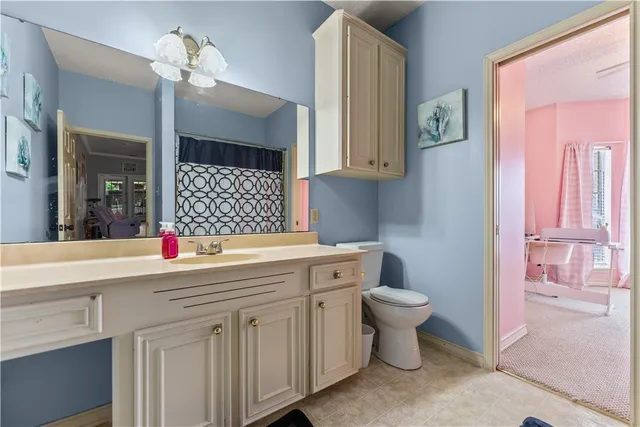 a view of patio with wooden chairs