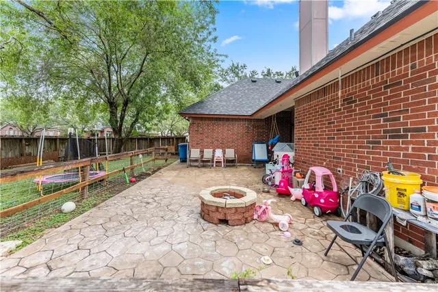 a view of a house with a yard and large tree