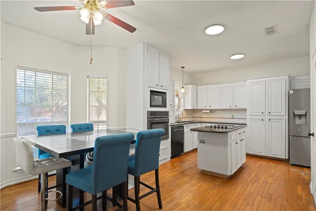 a kitchen with appliances cabinets and furniture
