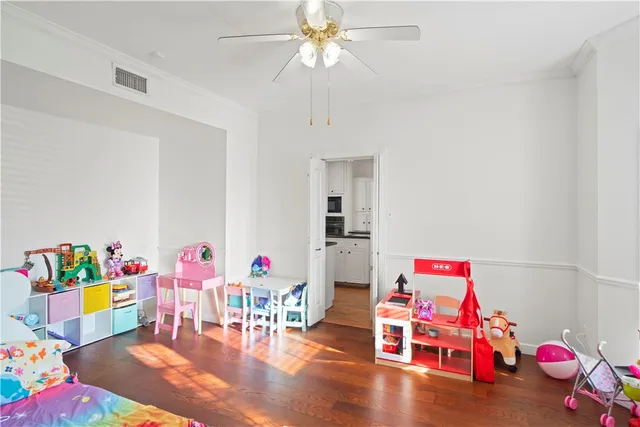 a bedroom with a bed and ceiling fan
