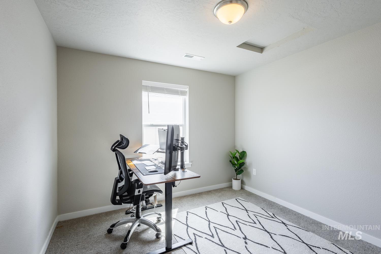 12623 Shadow Peak Street Caldwell, ID 83607 - Photo 39 of 50 Neutral-toned walls complement the light gray carpeting