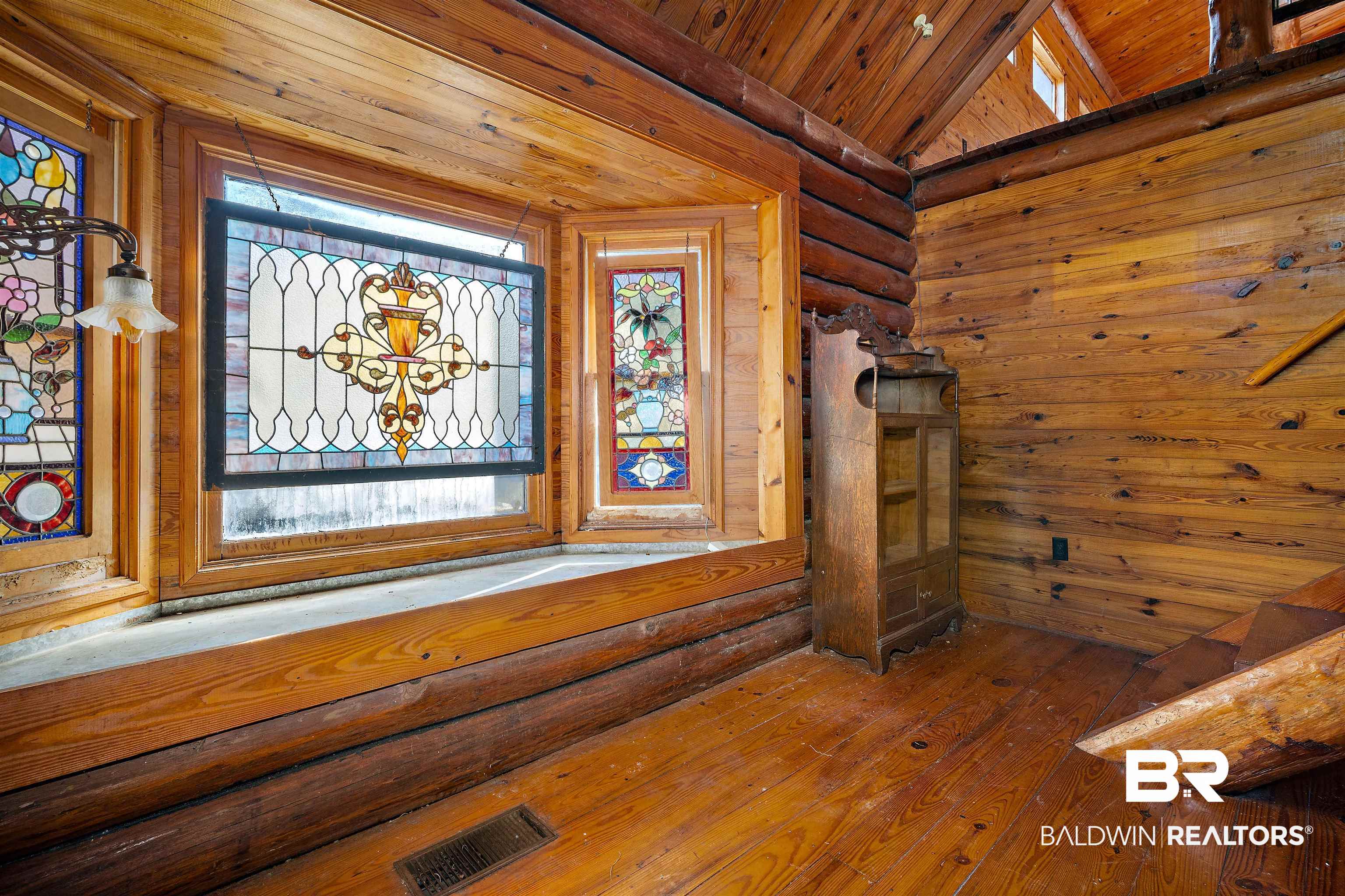 11236 Wren Avenue Fairhope, AL 36532 - Photo 10 of 35 Detailed view of log walls, wooden ceiling, and wood finished floors