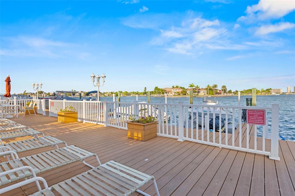 8921 Blind Pass Road, Unit 142 St. Pete Beach, FL 33706 - Photo 20 of 22 a view of a rooftop deck with lounge chairs