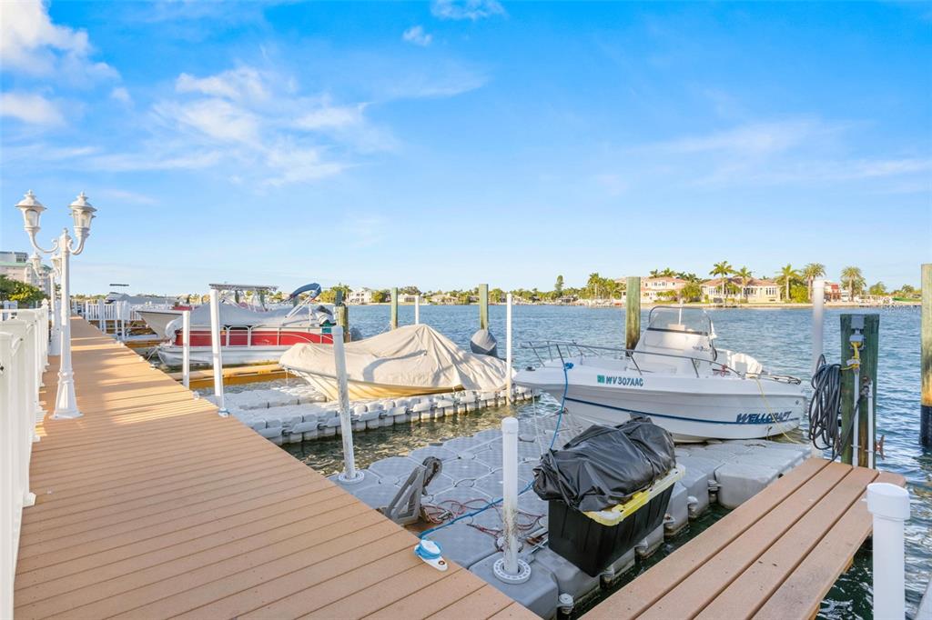 8921 Blind Pass Road, Unit 142 St. Pete Beach, FL 33706 - Photo 21 of 22 a view of a rooftop deck with couch and chairs