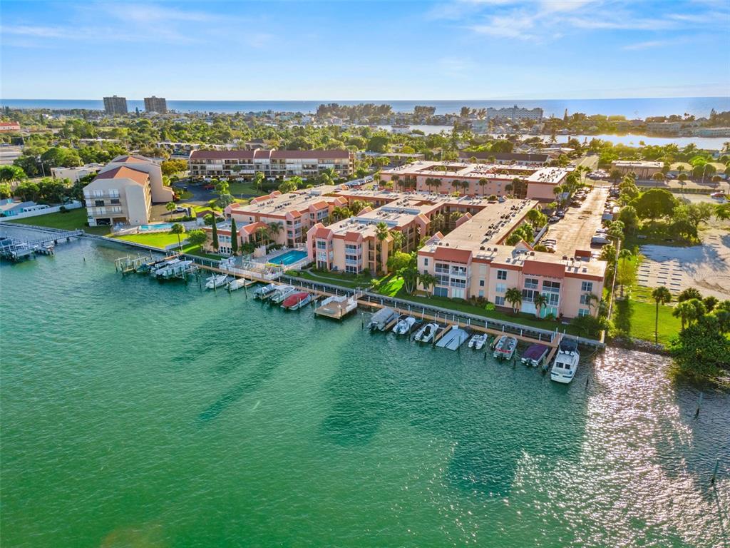 8921 Blind Pass Road, Unit 142 St. Pete Beach, FL 33706 - Photo 5 of 22 an aerial view of a house with a garden and lake view