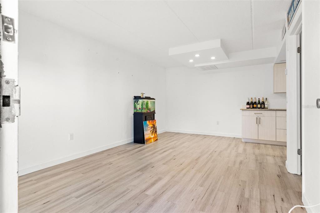 8921 Blind Pass Road, Unit 142 St. Pete Beach, FL 33706 - Photo 7 of 22 a view of an empty room with wooden floor