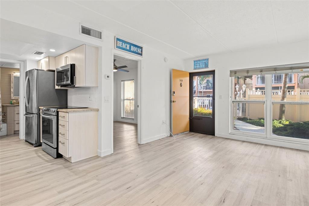 8921 Blind Pass Road, Unit 142 St. Pete Beach, FL 33706 - Photo 9 of 22 a view of kitchen with furniture and refrigerator