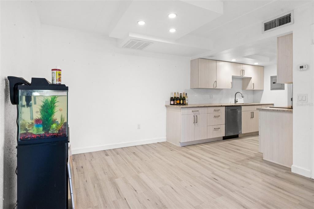 8921 Blind Pass Road, Unit 142 St. Pete Beach, FL 33706 - Photo 10 of 22 a kitchen with stainless steel appliances granite countertop a sink stove and refrigerator