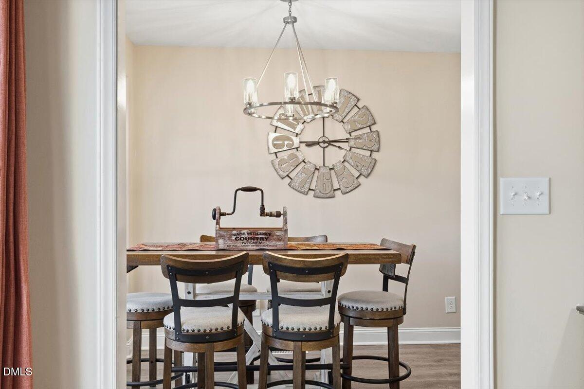 605 Oak Run Drive Raleigh, NC 27606 - Photo 12 of 28 a dining room with a table and chairs