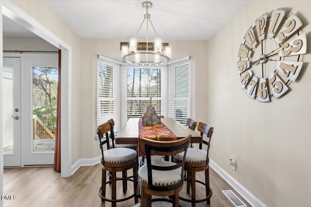 605 Oak Run Drive Raleigh, NC 27606 - Photo 13 of 28 a dining room with furniture and window