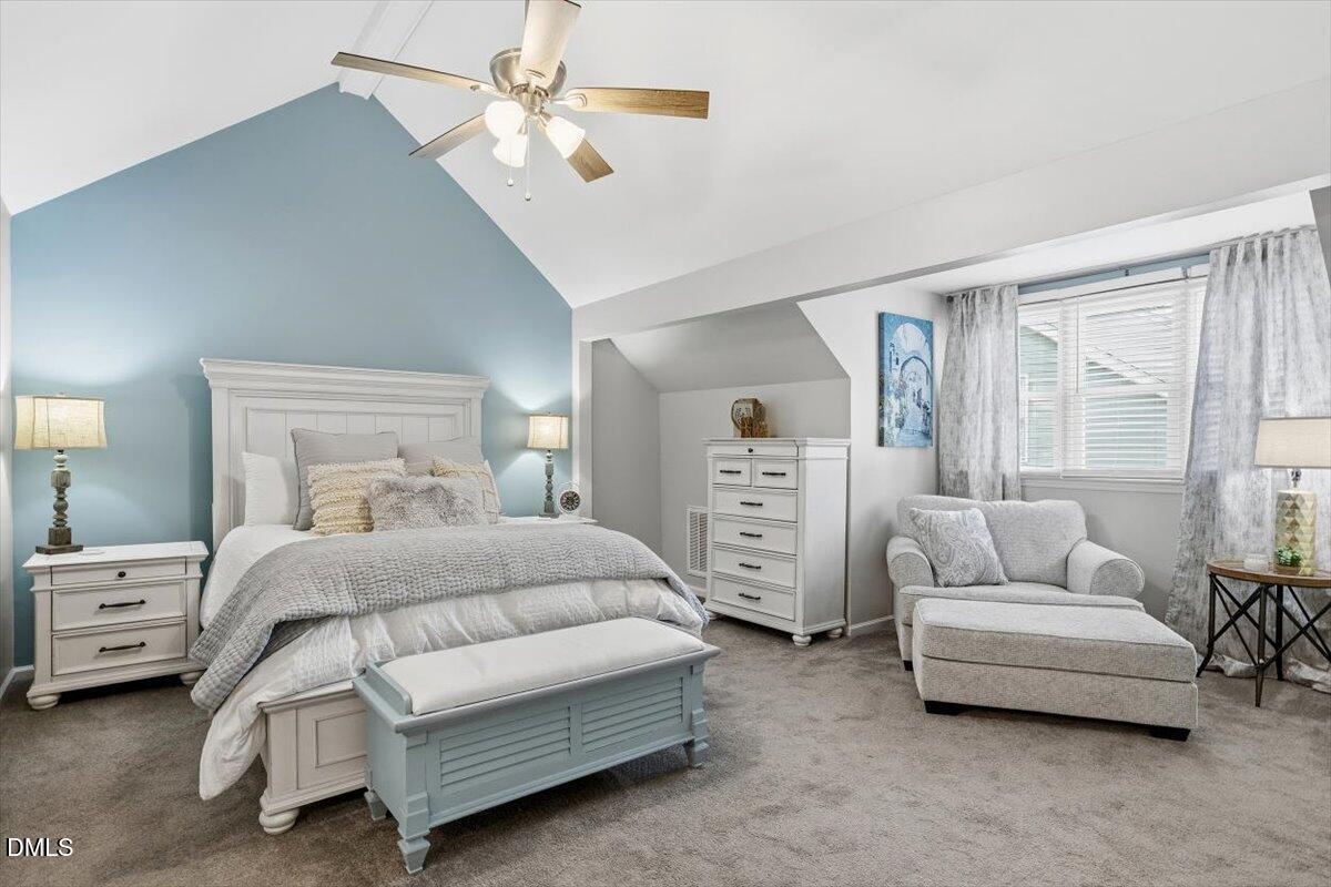 605 Oak Run Drive Raleigh, NC 27606 - Photo 18 of 28 a bedroom with bed and a chandelier