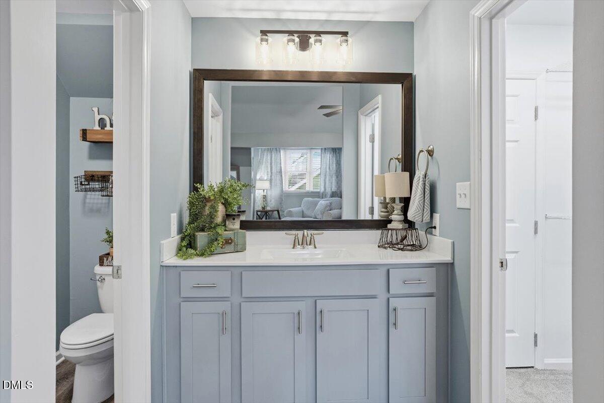 605 Oak Run Drive Raleigh, NC 27606 - Photo 21 of 28 a bathroom with a toilet sink and mirror