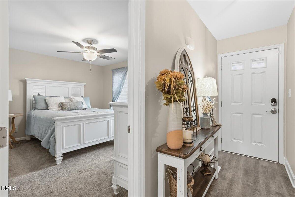 605 Oak Run Drive Raleigh, NC 27606 - Photo 8 of 28 a bedroom with a bed and a chandelier