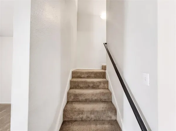 a view of staircase with white walls