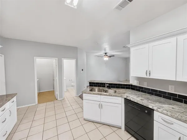 a kitchen with a stove a sink and a refrigerator