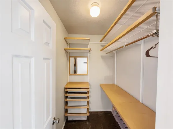a view of a hallway with staircase and white walls