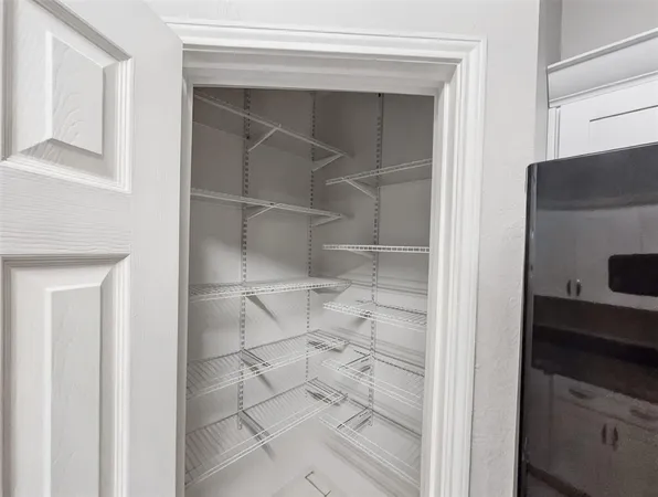 a bathroom with a walk in closet and mirror