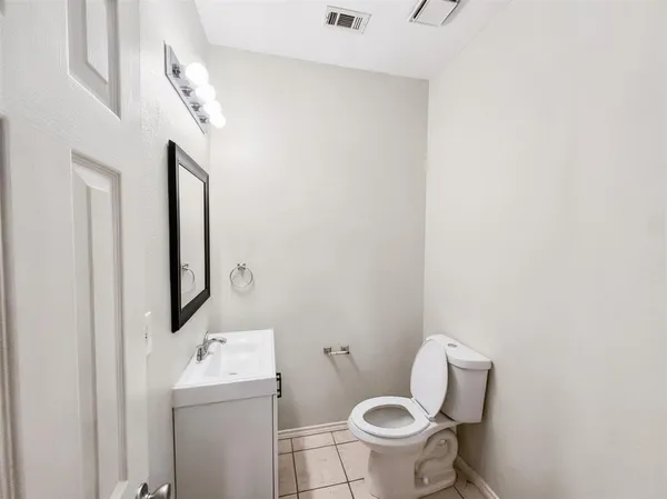 a white toilet sitting next to a bathroom sink