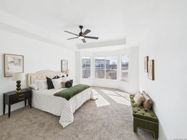a living room with furniture ceiling fan and a window